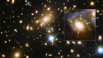 An image showing multiple galaxies and stars in deep space. An inset closeup shows the supernova Refsdal as a bright smudge